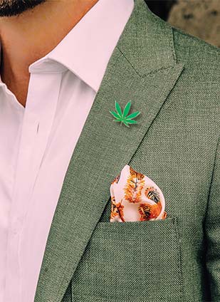 The Weed Lapel Pin on Green Coat